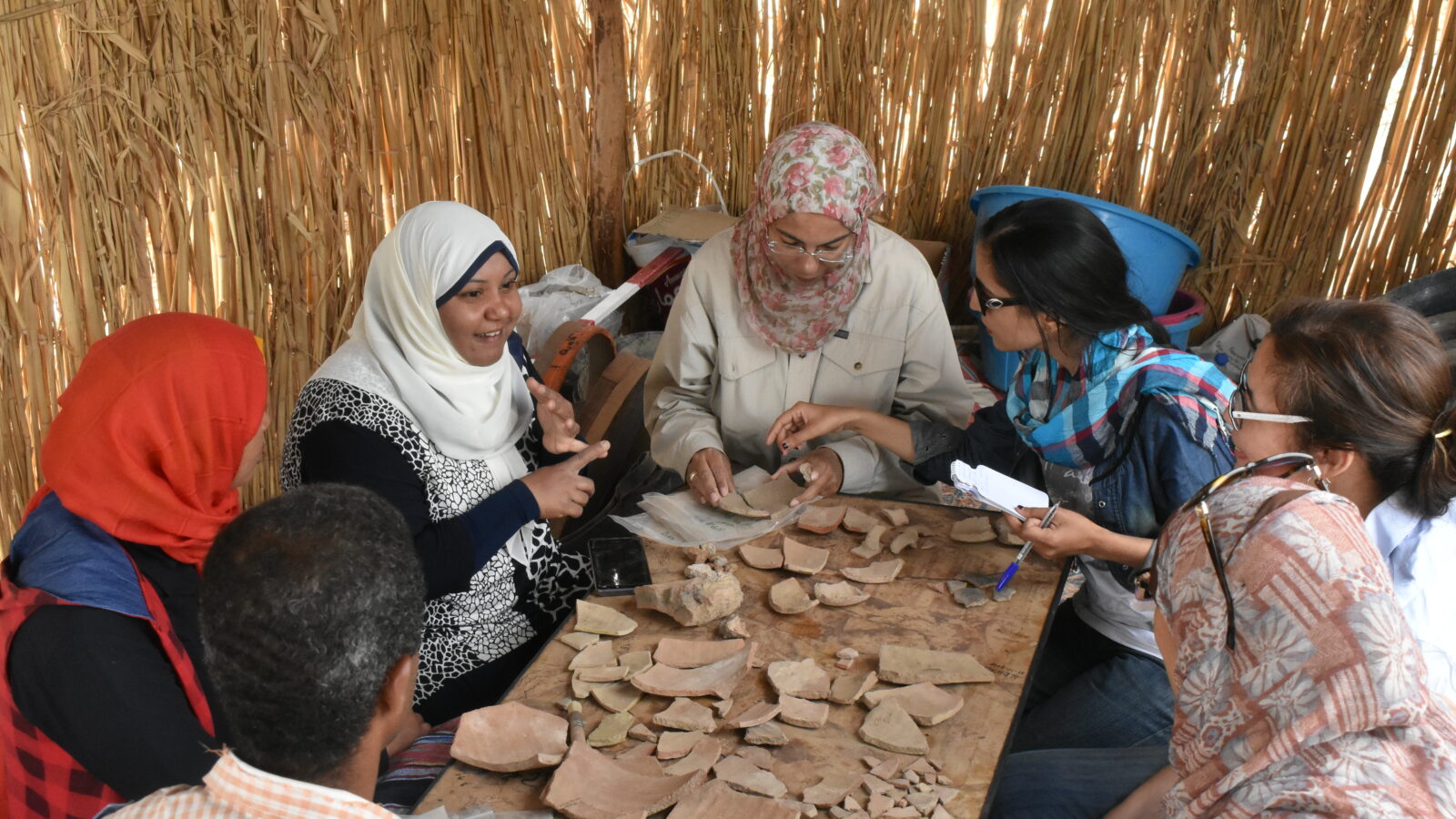 Women examine artefacts as part of cultural heritage Newton Prize project