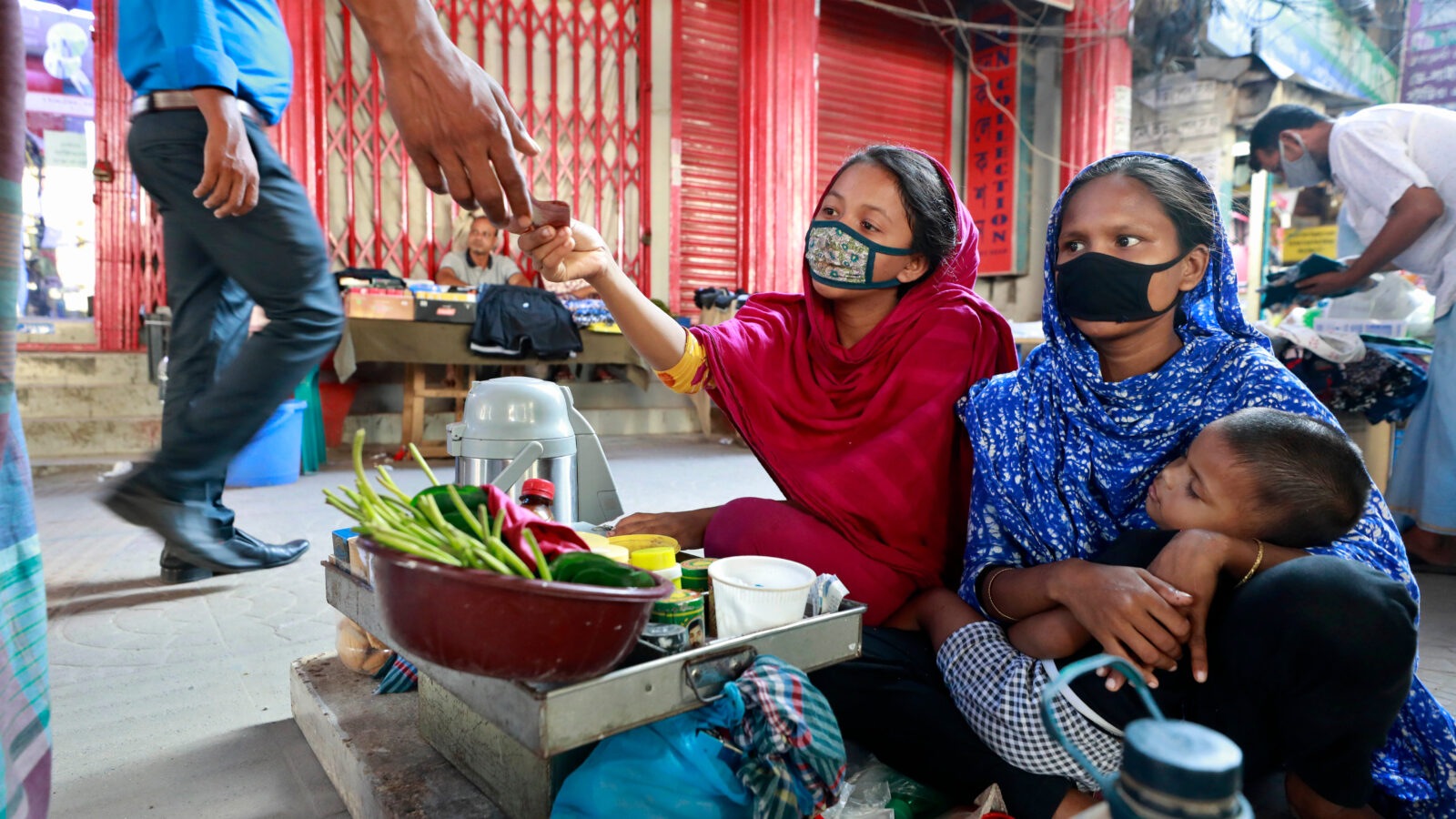 Women in Bangladesh working while caring for their children